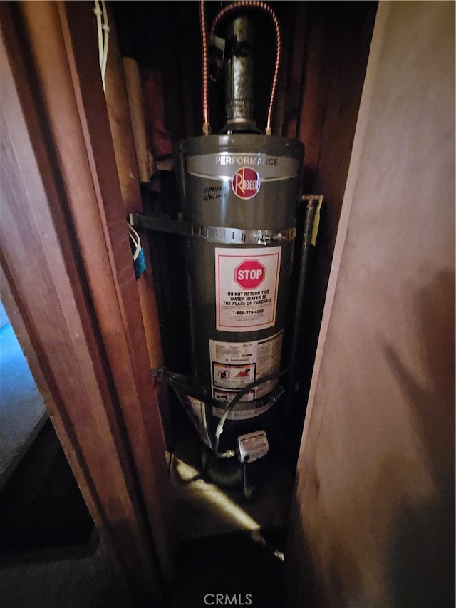 utility room featuring strapped water heater