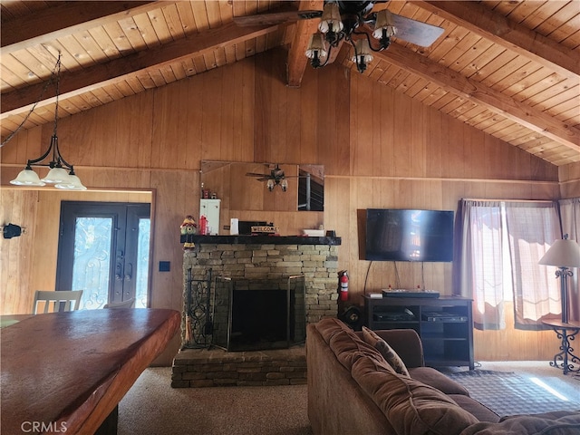 living room featuring wood walls, a fireplace, lofted ceiling with beams, and wood ceiling