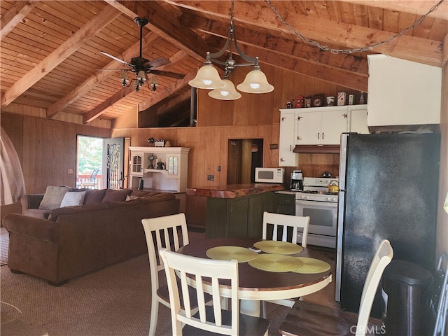 dining room featuring wooden walls, lofted ceiling with beams, wood ceiling, and ceiling fan