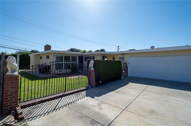 ranch-style house featuring a garage and a front lawn