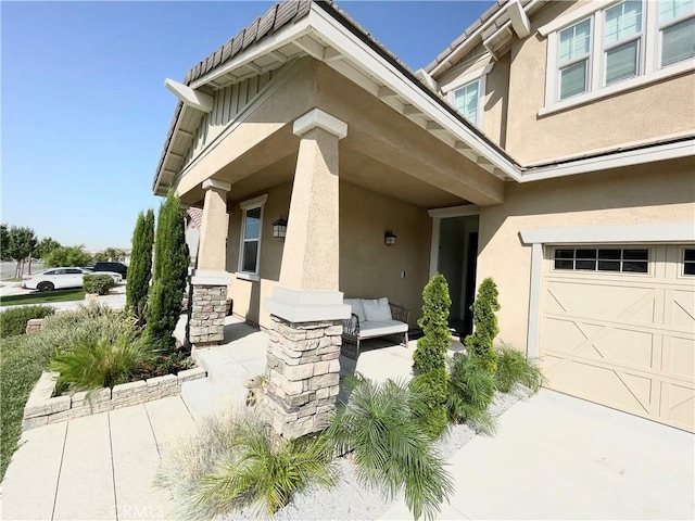 doorway to property with a garage