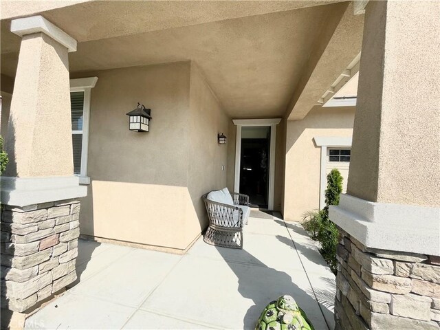 entrance to property with a patio area