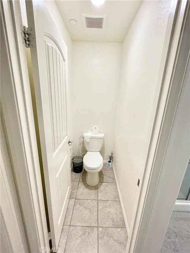 bathroom with tile patterned floors and toilet