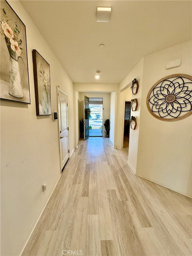 corridor with light hardwood / wood-style floors