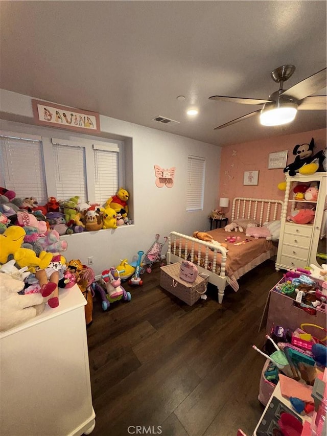 bedroom with dark hardwood / wood-style flooring and ceiling fan