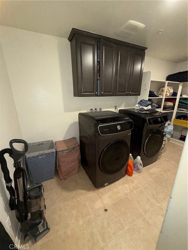 laundry area featuring cabinets and separate washer and dryer