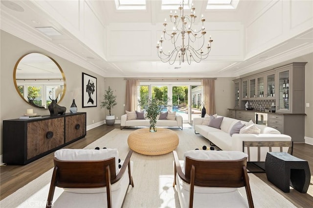 living room featuring a notable chandelier, dark hardwood / wood-style floors, bar, and french doors