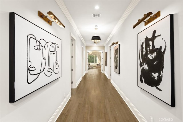 hallway with ornamental molding and dark wood-type flooring