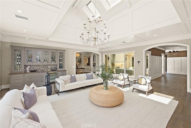 living room featuring dark hardwood / wood-style flooring, ornamental molding, and coffered ceiling