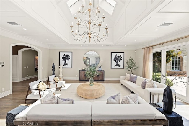 living room featuring hardwood / wood-style flooring, a notable chandelier, and ornamental molding