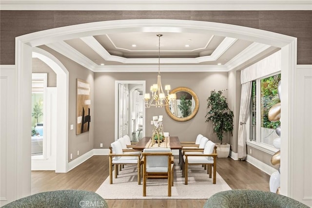 dining space featuring a chandelier, hardwood / wood-style floors, and a tray ceiling