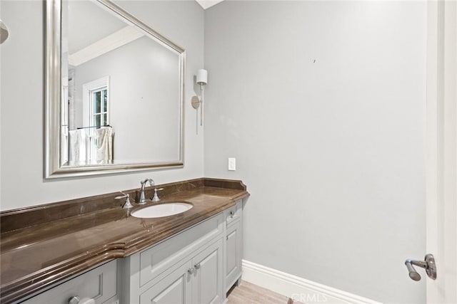 bathroom with hardwood / wood-style floors and vanity