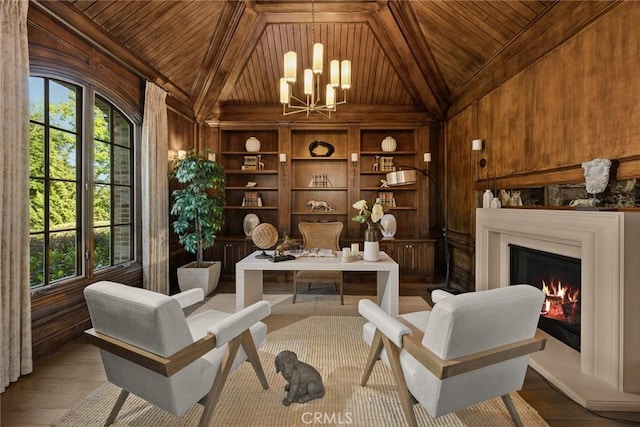 sitting room featuring hardwood / wood-style floors, a notable chandelier, wooden ceiling, and wooden walls