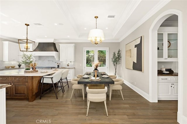 dining room with a chandelier, dark hardwood / wood-style flooring, and ornamental molding