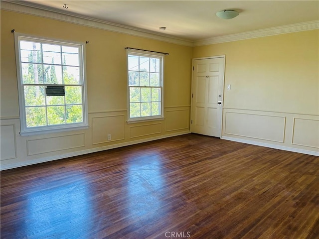 spare room with dark wood-type flooring and ornamental molding