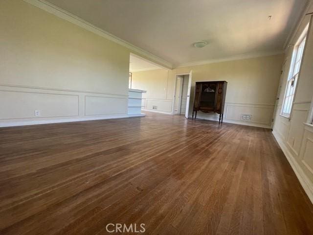 unfurnished living room with dark hardwood / wood-style flooring and crown molding