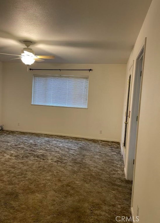 carpeted empty room with a textured ceiling and ceiling fan