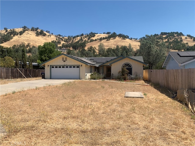 ranch-style house with a mountain view and a garage