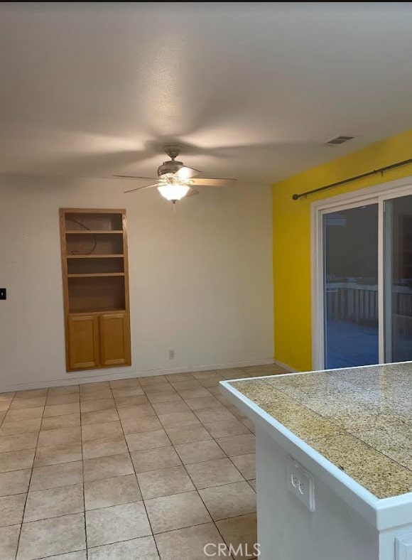 kitchen featuring light tile patterned floors and ceiling fan