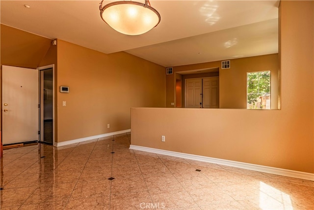 spare room featuring visible vents and baseboards