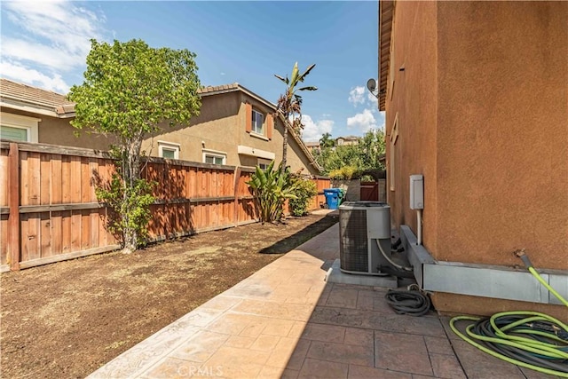 view of patio with a fenced backyard and central AC unit