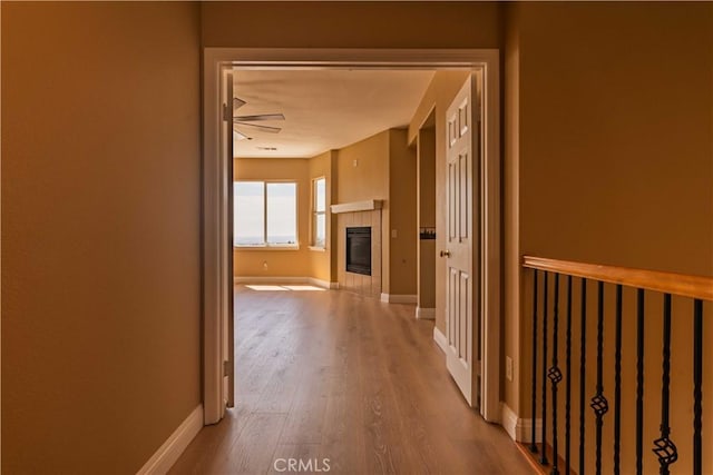 hall featuring baseboards and wood finished floors