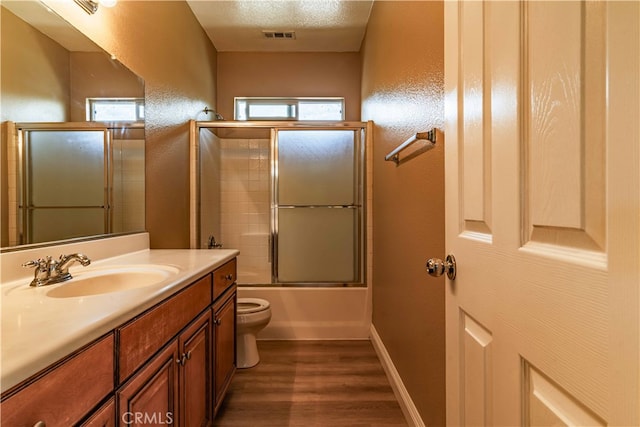 bathroom featuring a healthy amount of sunlight, visible vents, toilet, and wood finished floors