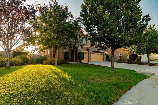 view of front of house with a garage and a front yard