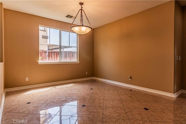 unfurnished room featuring visible vents and baseboards