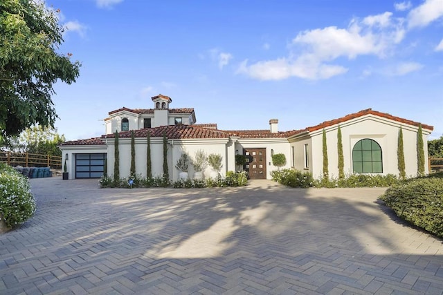 mediterranean / spanish-style house with a garage