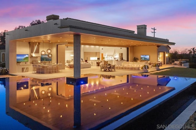 view of swimming pool with a patio, area for grilling, and a bar