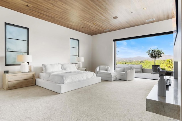 carpeted bedroom featuring a mountain view and wood ceiling