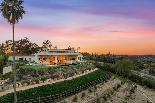 view of back house at dusk