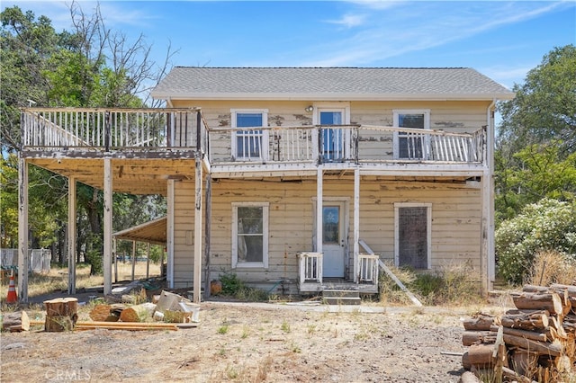 rear view of property featuring a balcony