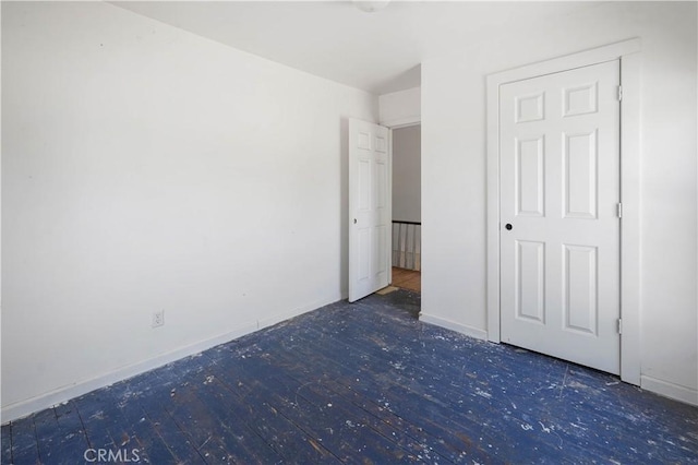 unfurnished bedroom with dark hardwood / wood-style floors