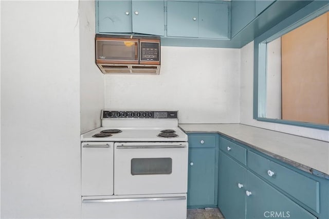 kitchen featuring double oven range and blue cabinetry