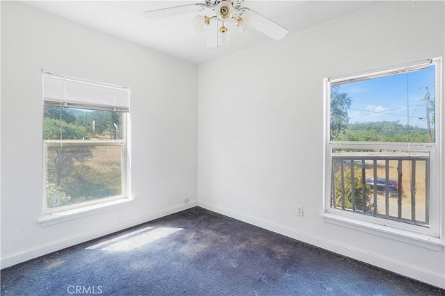 carpeted spare room featuring ceiling fan