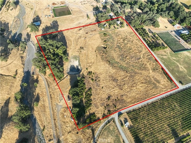 birds eye view of property with a rural view