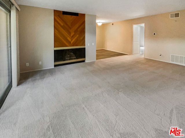 unfurnished living room featuring carpet floors