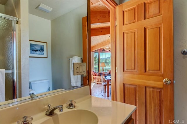 bathroom featuring walk in shower, vanity, a notable chandelier, toilet, and lofted ceiling