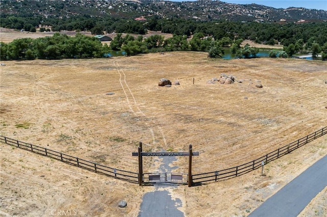 drone / aerial view featuring a water and mountain view and a rural view