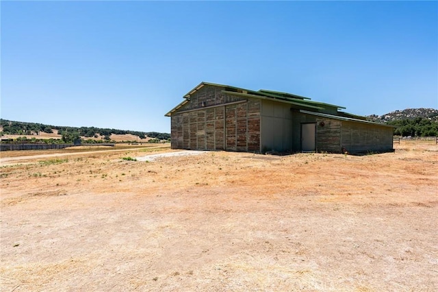 exterior space featuring an outbuilding and a rural view