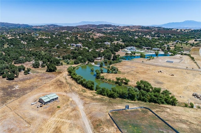 aerial view featuring a water and mountain view