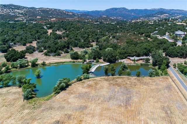 birds eye view of property with a water and mountain view