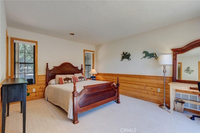 bedroom with carpet and wooden walls