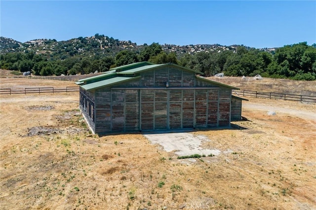 view of outbuilding with a rural view