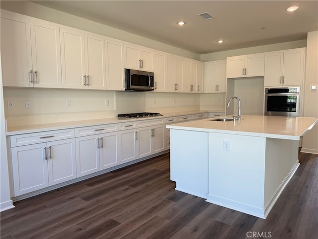 4811 Swallowtail Ln, Fontana, CA 92336 - kitchen featuring appliances with stainless steel finishes, a sink, dark wood-type flooring, white cabinetry, and recessed lighting