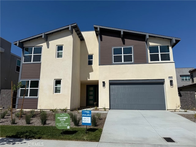 4811 Swallowtail Ln, Fontana, CA 92336 - view of front of house featuring stucco siding, an attached garage, and concrete driveway