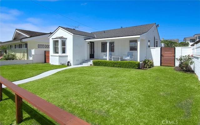 view of front of home featuring covered porch and a front yard