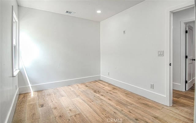 spare room featuring light wood-type flooring